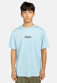 Light blue cotton t-shirt featuring black "Element" text at the center. Boxy fit with short sleeves and round neckline.