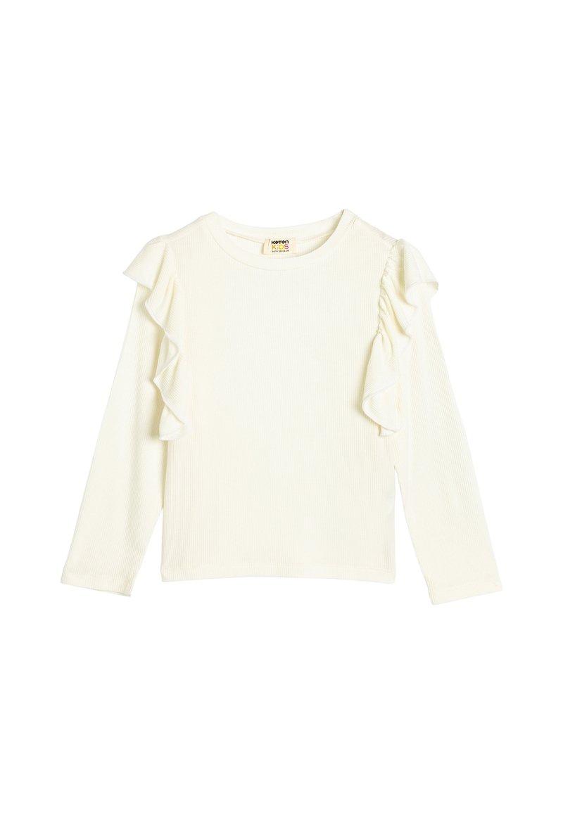 Pitkähihainen ribbikuvioitu paita off-white-värissä, jossa on kerrokselliset volangikoristeet yhdellä olkapäällä. Ominaisuuksiin kuuluu pyöreä pääntie ja suora helma.