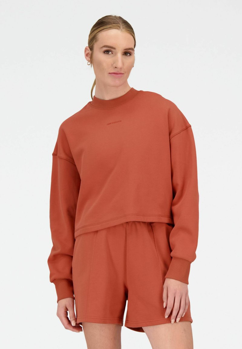 Rustkleurige sweatshirt en shorts set gemaakt van zacht materiaal, met een ontspannen pasvorm, ribgebreide manchetten en een subtiele logo op de borst.