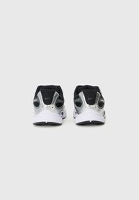 Black and silver athletic shoes with mesh upper, textured accents, reflective detailing, and contrasting white sole. Focus on rear view.