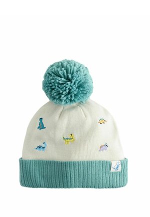 Bonnet enfant tricoté blanc et bleu sarcelle avec pompon bleu et petits motifs brodés de dinosaures colorés.