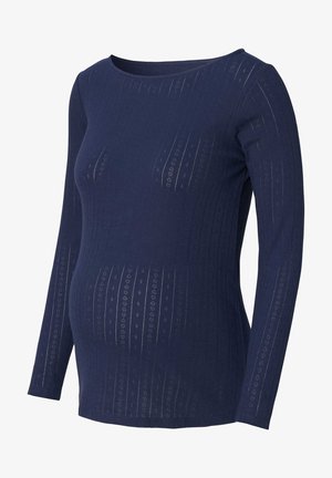 Haut de maternité bleu marine à manches longues, en tissu côtelé avec des motifs texturés subtils pour plus de détails et d'élasticité.