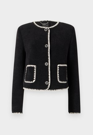 Black jacket with white scalloped trim, round neckline, and six front buttons. Features two patch pockets with matching trim. Textured fabric.