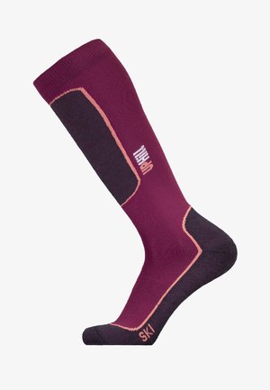 Ski socks in dark burgundy and black with textured fabric, reinforced heel, light pink accents, and branding on the side.
