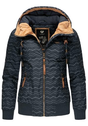 Veste bleu marine avec un motif en chevron, accents beige, fermeture éclair à l'avant, capuche avec cordon de serrage ajustable, et poignets et ourlet côtelés.