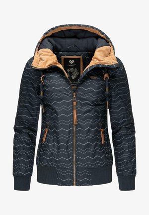 Veste bleu marine avec un motif en chevron, accents beige, fermeture éclair à l'avant, capuche avec cordon de serrage ajustable, et poignets et ourlet côtelés.