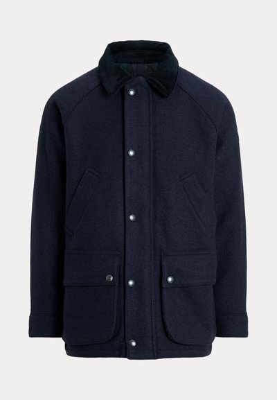 Navy blue coat made of textured fabric with a corduroy collar, snap buttons, and two front pockets for practicality.