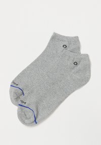 Calcetines de algodón grises hasta el tobillo con una textura suave, que presentan un acento azul en el puño y un detalle de logo negro cerca de los dedos.