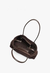 Brown canvas tote bag with leather handles, open view showcasing interior zipper pocket and fabric lining. Simple, structured design.