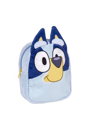 Blue plush backpack shaped like a dog's face, featuring large eyes, a yellow nose, and ear accents. Zipper closure, soft texture.