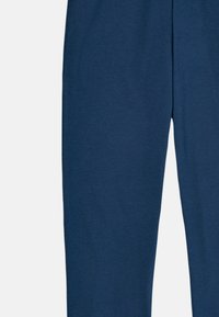 Navy blue, soft cotton blend joggers with a relaxed fit, featuring an elastic waistband and no visible pockets or patterns.