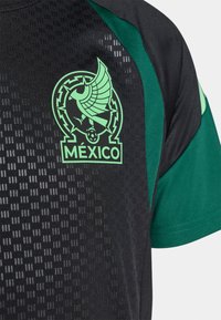 Black sports jersey with green accents, featuring a textured pattern and a logo with a stylized bird and the word "MÉXICO."