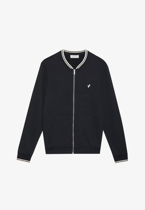 Black zip-up bomber jacket with white striped collar and cuffs, featuring a small white logo on the chest and front pockets. Soft fabric.