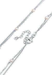 Zilveren ketting met kleine ivoorwitte parels, ingewikkelde schakels en een lobster sluiting met een verstelbare ketting voor lengte-aanpassing.