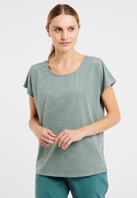 Korte mouwen, lichtgroen top met een textuurpatroon en ronde halslijn, gemaakt van lichtgewicht stof, gecombineerd met tealbroeken.