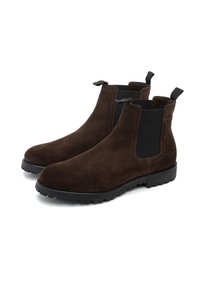Botas de tobillo de ante marrón con paneles laterales elásticos, lengüetas de tirón y una suela de goma texturizada, con una puntera redondeada y un diseño elegante.