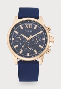 Orologio cronografo con cinturino in silicone blu navy, cassa in acciaio inossidabile dorato e quadrante blu scuro con indici e sottodial in argento.