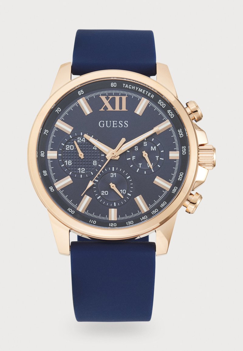 Orologio cronografo con cinturino in silicone blu navy, cassa in acciaio inossidabile dorato e quadrante blu scuro con indici e sottodial in argento.