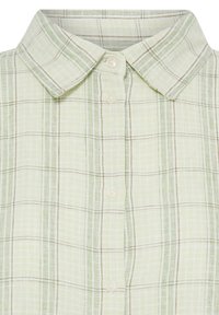 Chemise à carreaux vert clair avec un col classique et quatre boutons crème sur le devant.