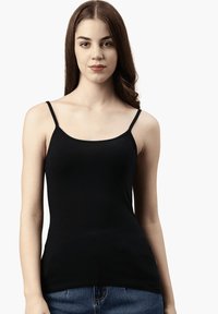 Schwarzes Camisole-Top mit dünnen Trägern, glatter Textur und tailliertem Schnitt. Getragen mit hochgeschnittenen Denim-Shorts, minimalistisches Design.