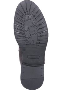 Černá gumová podrážka boty s texturovaným vzorem, obsahující drážky a kruhové akcenty pro lepší přilnavost. Velikost označená jako 37.