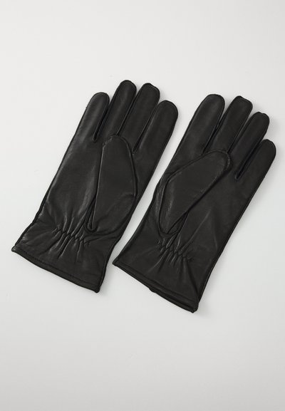 Et par sorte læderhandsker med sammensnørede håndled, lagt fladt på en lysegrå overflade, der viser for- og bagsiden.