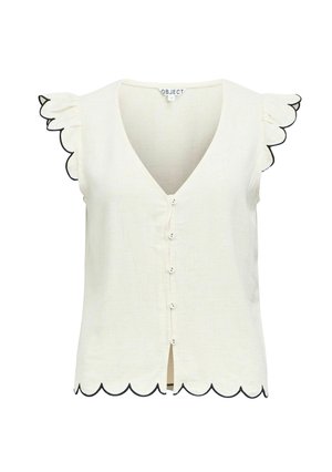 Blouse crème sans manches avec bords festonnés sur les manches et l'ourlet, petits boutons devant et encolure en V.