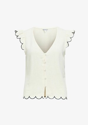 Blouse crème sans manches avec bords festonnés sur les manches et l'ourlet, petits boutons devant et encolure en V.