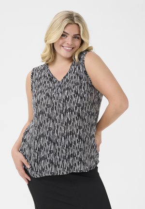Top sans manches noir et blanc avec un col en V, présentant des rayures verticales et des motifs de points variés, fabriqué en tissu léger.