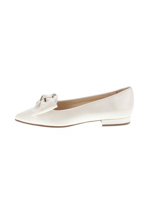Cream-colored flat shoe with pointed toe and decorative bow on front, featuring low square heel and smooth finish.