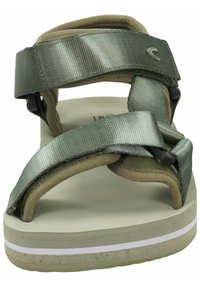 Green sandals with fabric straps, a cushioned footbed, and a textured sole. Features a white accent stripe on the edge of the sole.
