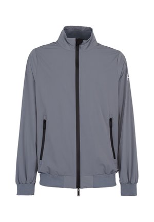 Veste légère grise avec un col montant, une fermeture éclair noire à l'avant, des poches latérales zippées et des poignets et un ourlet élastiques.