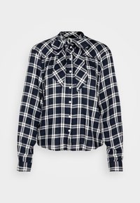 Navy and white checkered blouse with a bow tie collar, button front, and long sleeves; features gathered detailing and a cropped design.