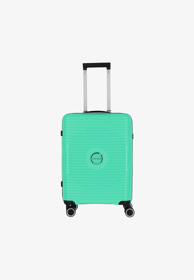 Hard-shell suitcase in mint green with horizontal ribbed texture, retractable handle, and four black wheels. Features a circular logo in the center.