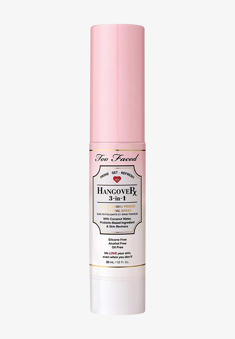 Pink cylindrical bottle with a white base, gold accents, and a label indicating it is a 3-in-1 primer and setting spray, 30 ml.
