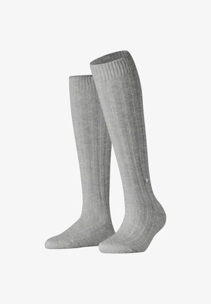 Graue knielange Socken mit geripptem Muster. Aus weichem Material gefertigt und mit einer kleinen Verzierung an der Seite.