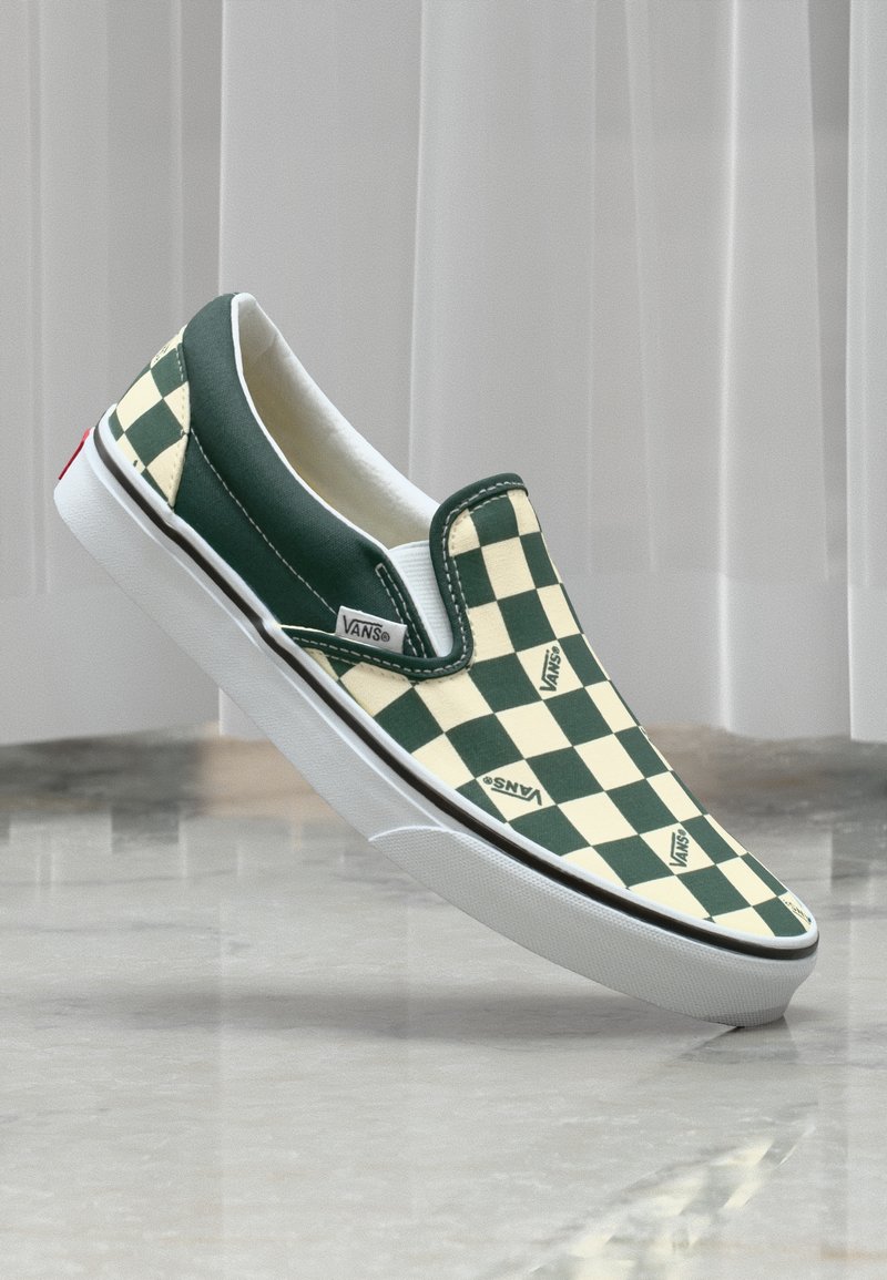 Roheline ja kreemjas ruuduline slip-on Vans suss valge tallaga ja brändingu aktsentidega. Sile tekstiilpealne, voolav disain.