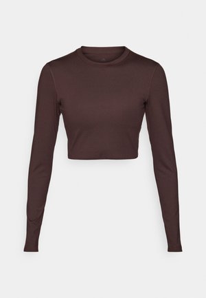 Langærmet, cropped top i mørkebrun, lavet af glat, strækbart stof. Har rund halsudskæring og tætsiddende ærmer med minimal syningsdetalje.