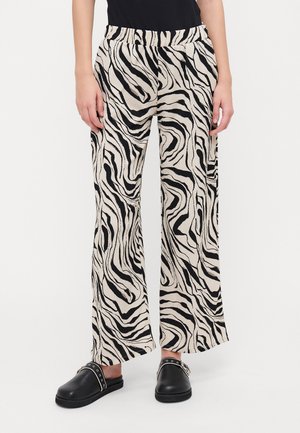 Pantalons à jambes larges avec un motif zèbre, présentant un schéma de couleurs noir et blanc. Fabriqués en tissu texturé avec une taille élastique.