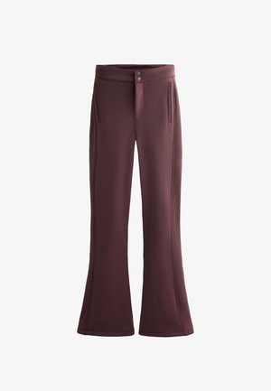 Pantaloni a zampa di colore marrone scuro realizzati in tessuto elasticizzato, con due tasche laterali con zip e chiusura con bottone in vita.