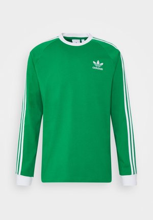 Chemise verte à manches longues en coton. Caractérisée par un col rond, trois bandes blanches le long des manches, et un petit logo blanc sur la poitrine.