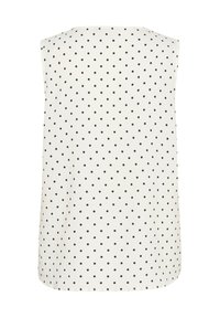 Top sans manches en tissu léger, avec une base blanche et des pois noirs. Encolure ronde et ourlet légèrement arrondi.