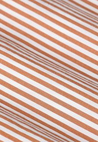 Fabric featuring alternating brown and white stripes, smooth texture, and a consistent pattern throughout the material.