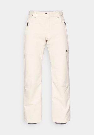 Lichtbeige sneeuwbroek met een recht gesneden ontwerp, zijzakken, versterkte stiksels en een logo-detail. De stof lijkt glad en duurzaam.
