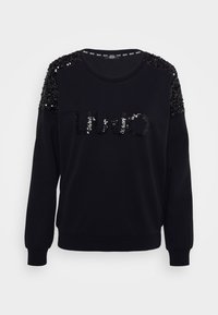Sudadera negra con un logotipo de lentejuelas y hombros adornados. Tejido suave con puños y dobladillo acanalados para un ajuste cómodo.