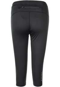 Svarta capri leggings i stretchtyg, med en figurnära design, en ficka med dragkedja och dekorativa detaljer nära fållen.
