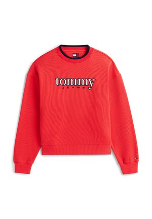 Punainen ribbineulottu collegepaita, jossa on pyöreä pääntie ja pitkät hihat. Paidassa on kirjailtuna kontrastiväreillä sanat "tommy" ja "JEANS".