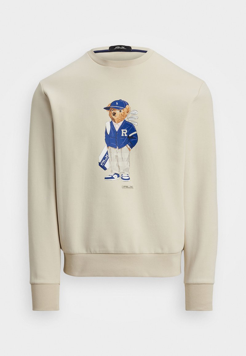 Felpa beige con grafica di un orso in giacca blu, che tiene delle mazze da golf, con polsini a costine e scollatura rotonda.