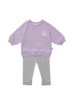 Lilac sweatshirt with smiley face graphic, paired with black and white striped leggings. Soft fabric, relaxed fit, ribbed cuffs.