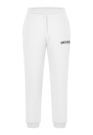 Bílé tepláky vyrobené z bavlněné směsi, s pasem na šňůrku, žebrovanými manžetami a vyšit�ým logem "SMILODON" na levém stehně.